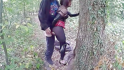 Latexed brunette babe riding a hard dick in the woods
